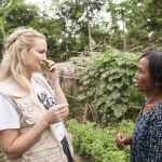 KATE HUDSON WITH WOMAN ON CAMBODIAN FARM