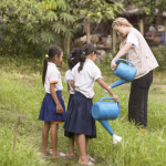 KATE WATERING CROPS ON FARM