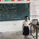 GIRL AT SCHOOL WITH CHALKBOARD