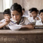 CAMBODIAN STUDENT EATING AT SCHOOL